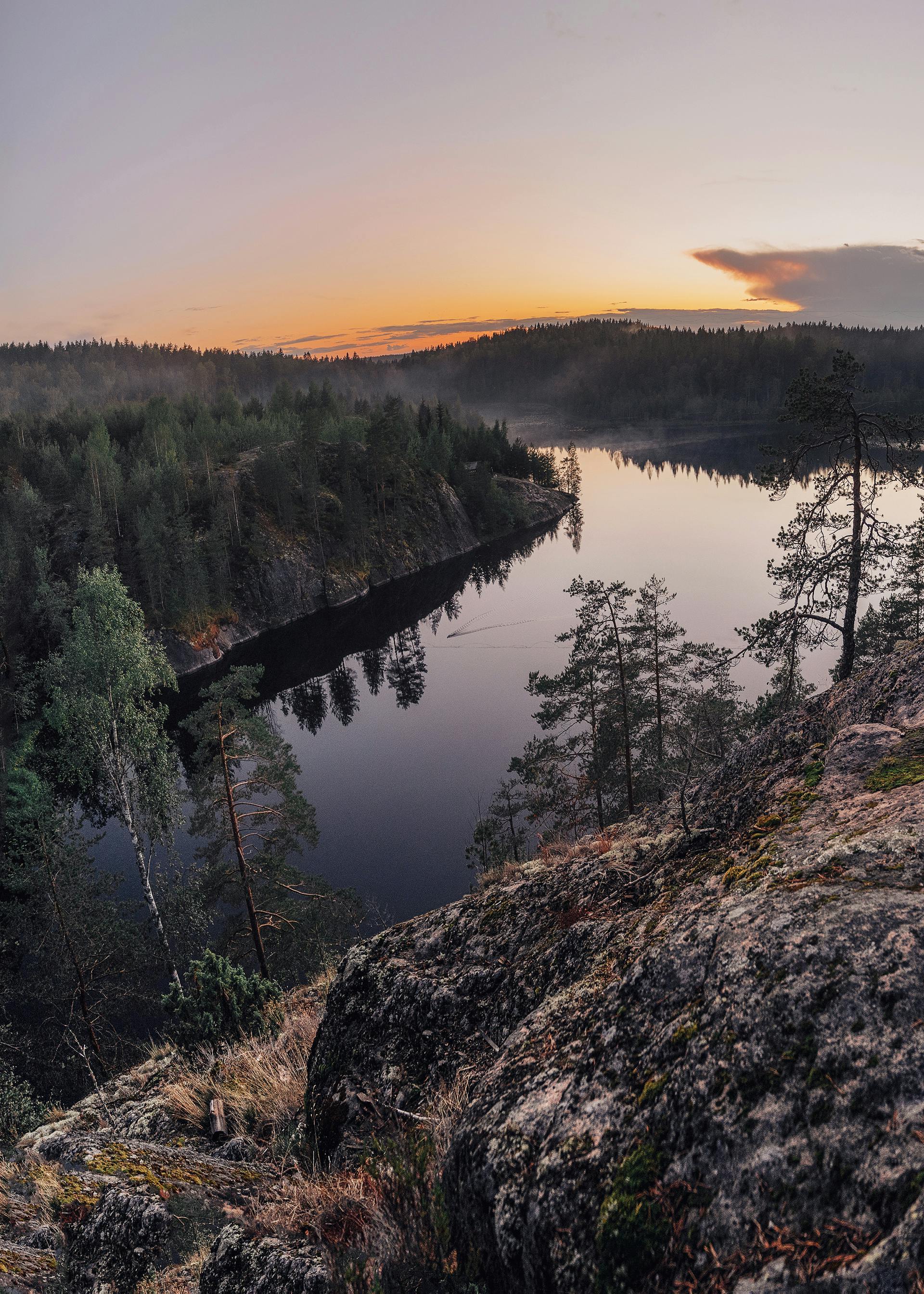 Finnish lake at sunset viewed from rocky cliff